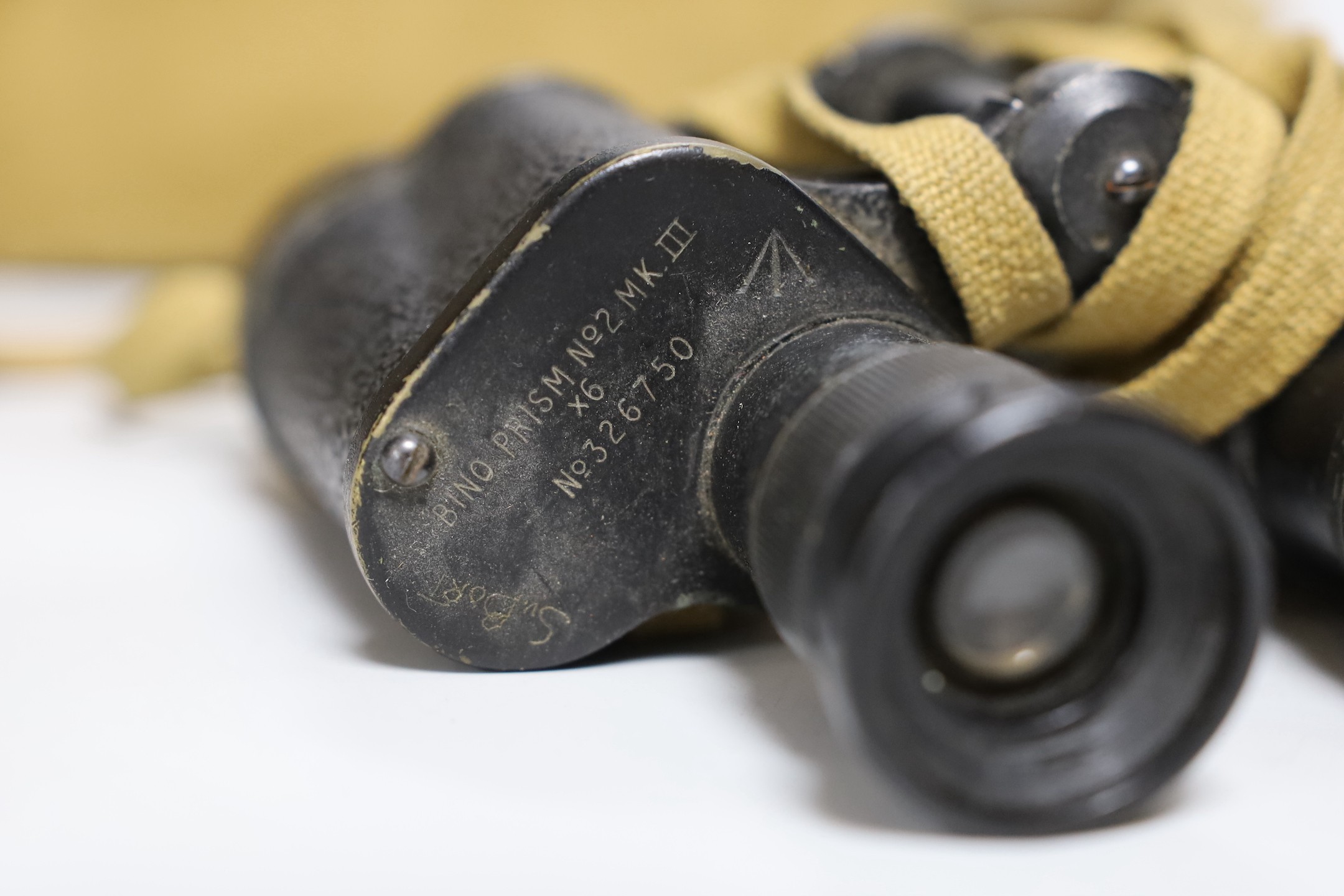 A British WWII military helmet and a pair of Kershaw military binoculars No. 326750